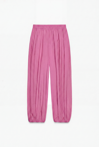 Pink satin wide-leg pants with elastic waistband, full-length and gathered cuffs.