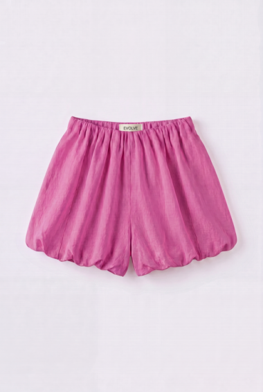 Pink satin bubble skirt with an elastic waist and gathered panels, laid flat on a pale background; tag reads EVOLVE on the waistband.